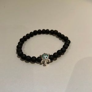 Black bracelet with turtle